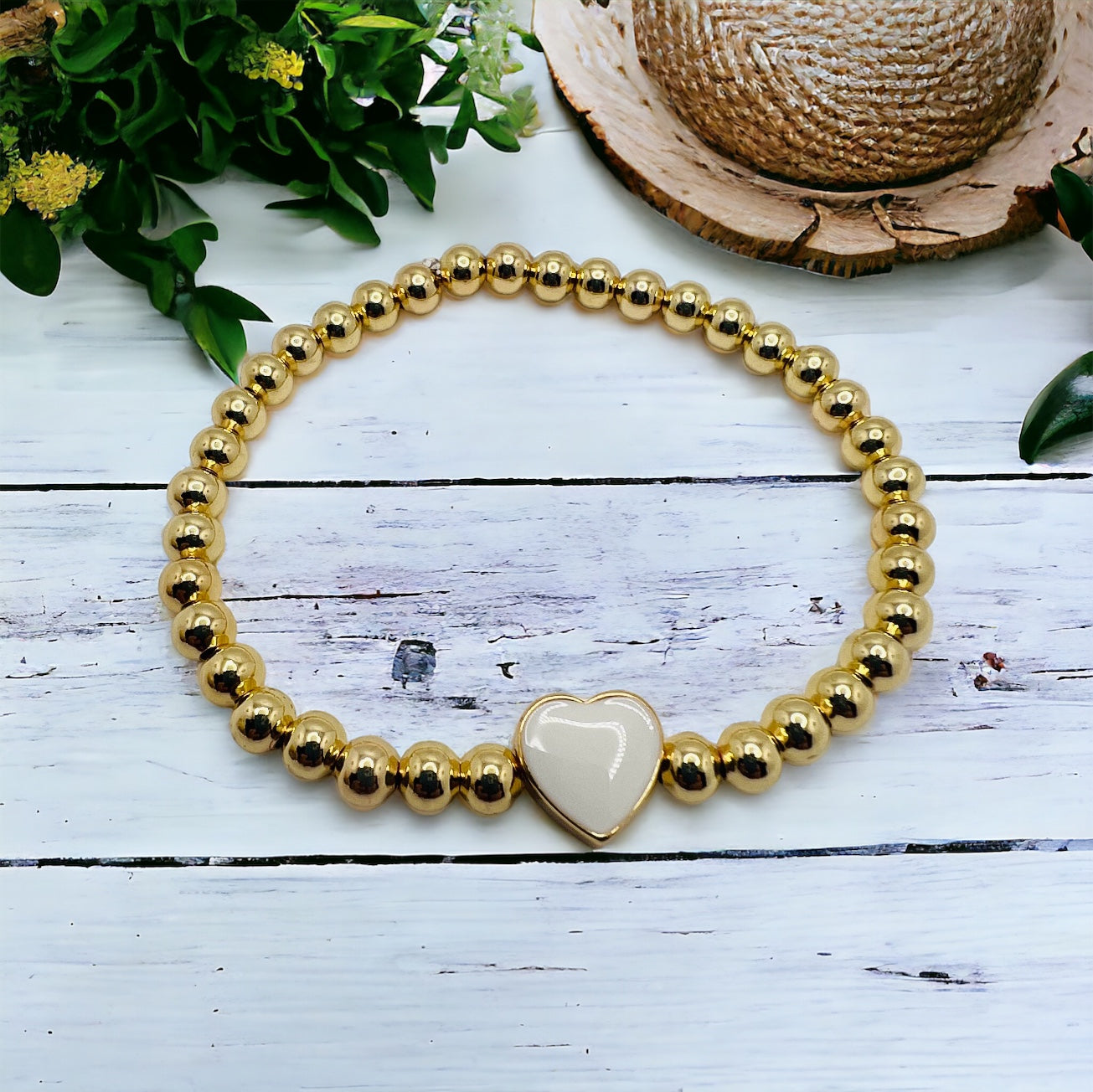 Gold bracelet with white heart