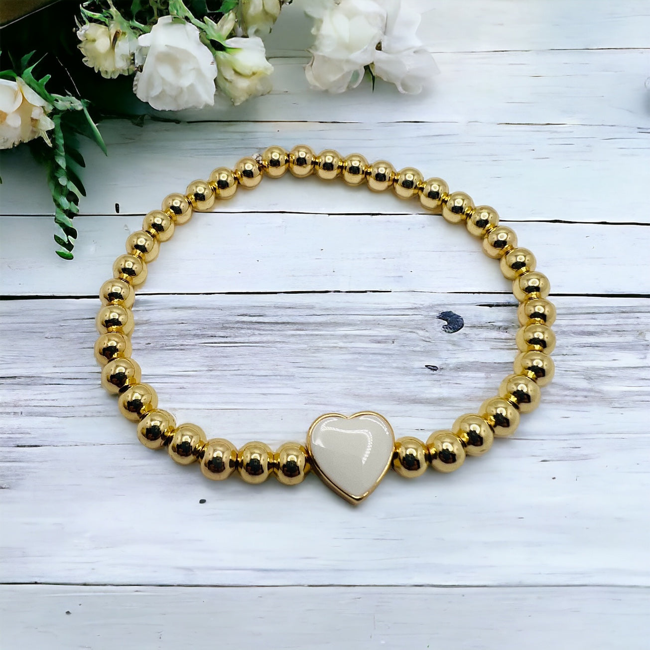 Gold bracelet with white heart