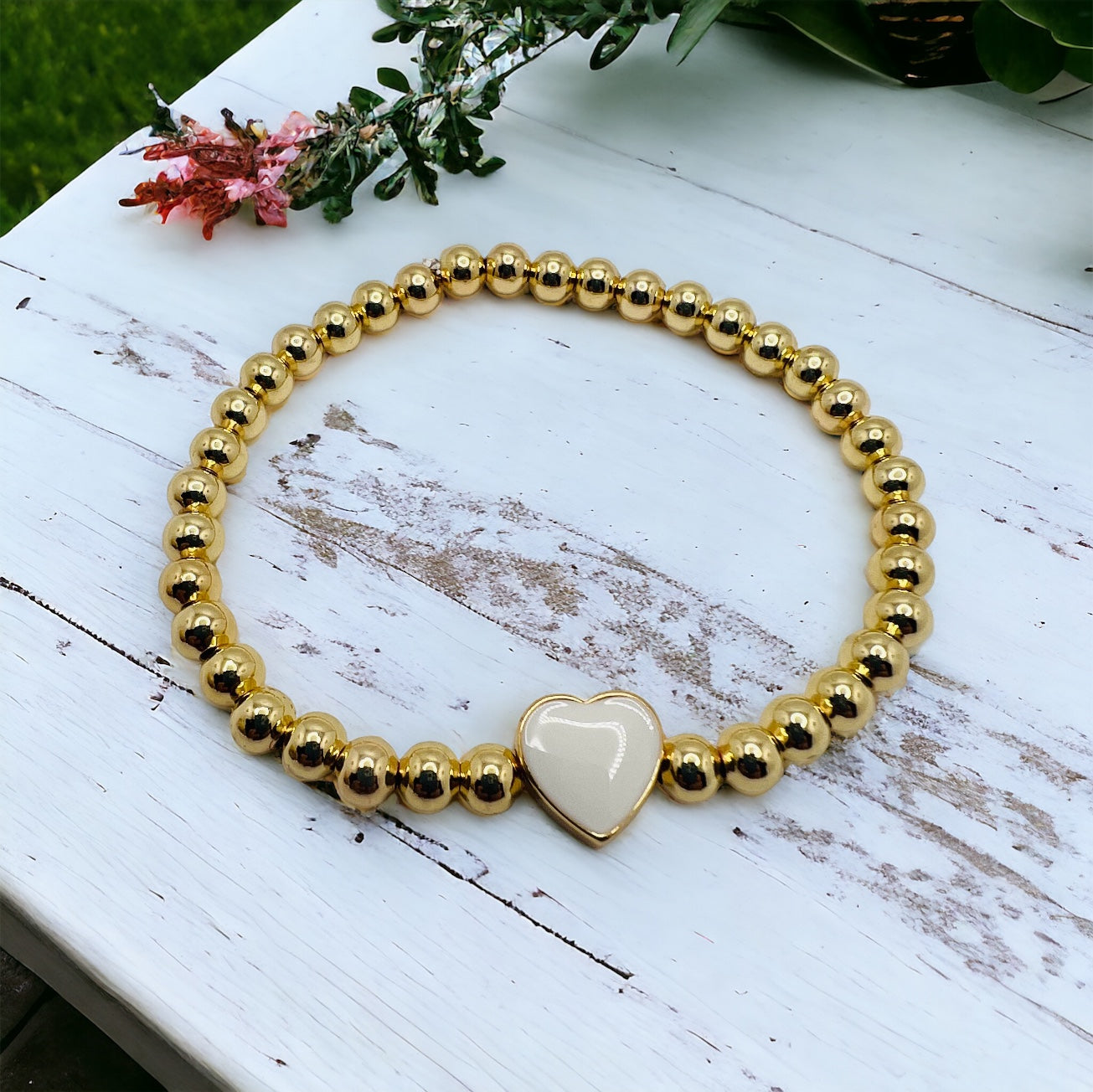 Gold bracelet with white heart