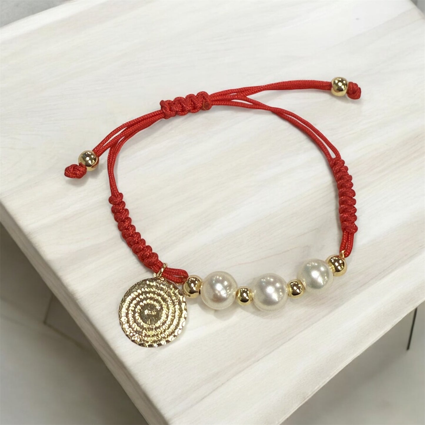 Red cord pearls and our father prayer