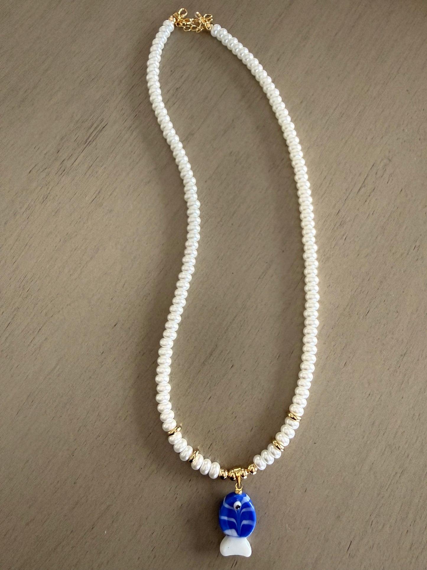 Pearl necklace with blue fish charm