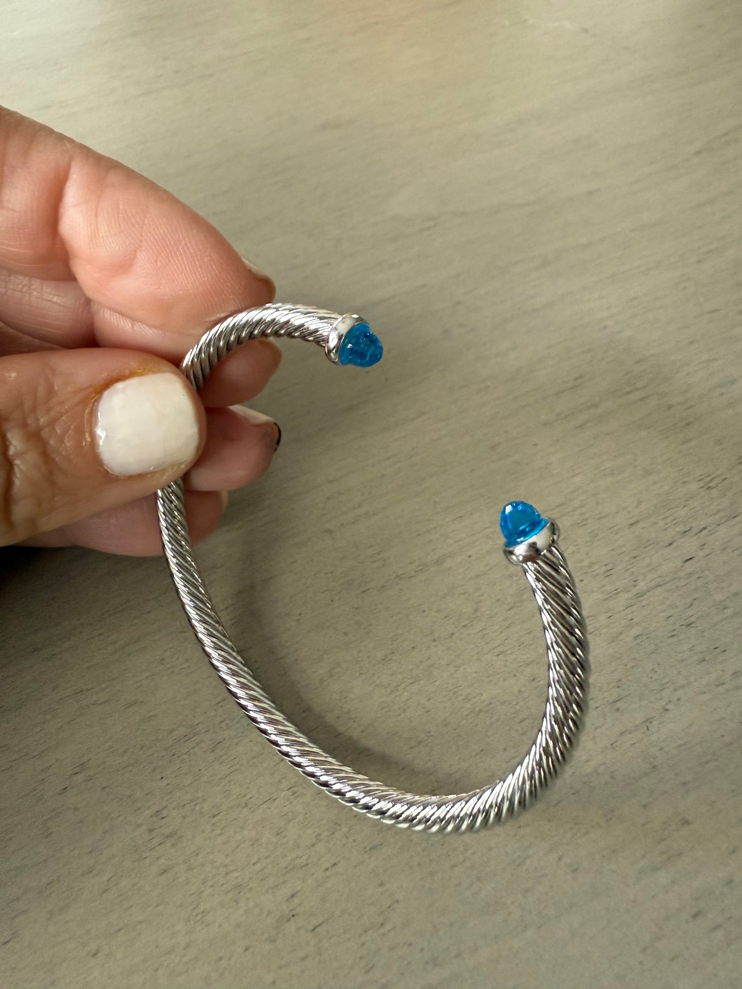 Silver twist cable cuff bracelet with blue tips