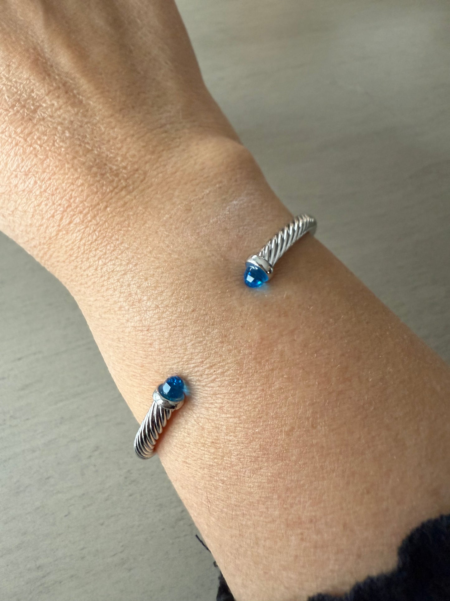 Silver twist cable cuff bracelet with blue tips
