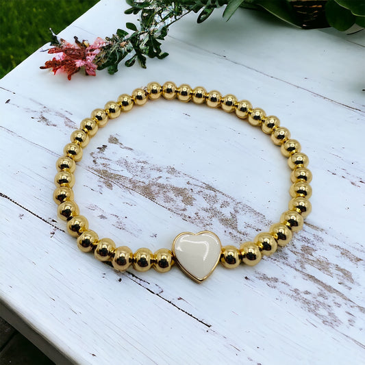 Gold bracelet with white heart