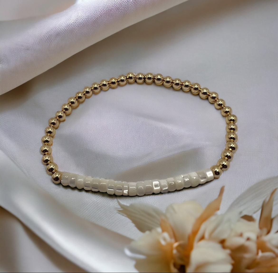 Gold bracelet with mother of pearl beads