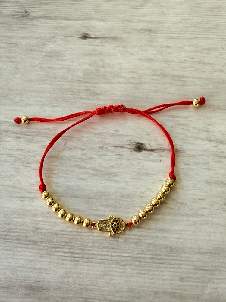 Red cord hamsa hand
