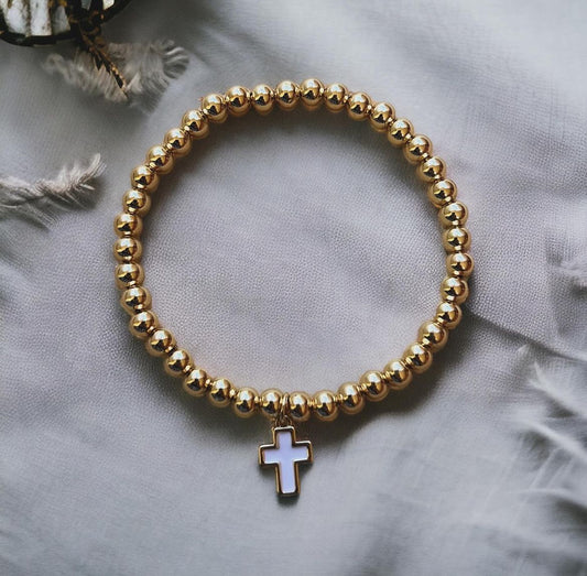 Gold bracelet with white cross