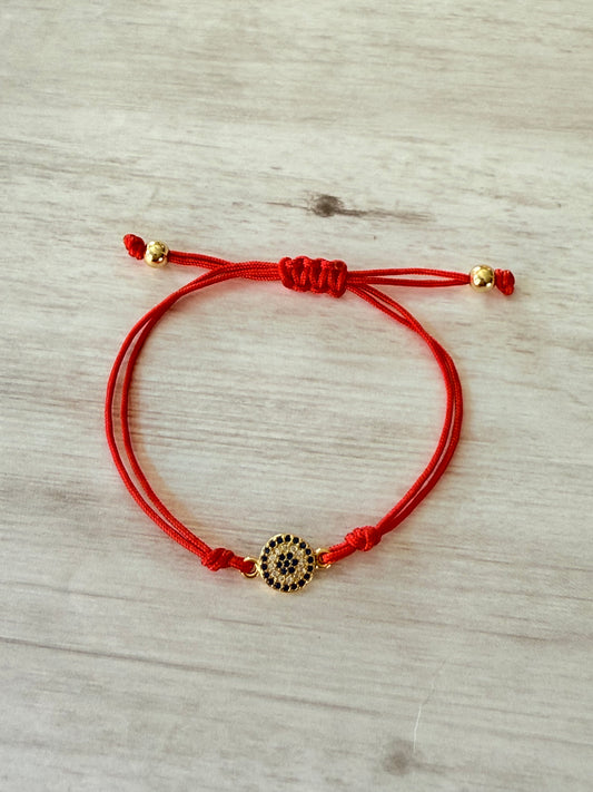 Red cord gold evil eye