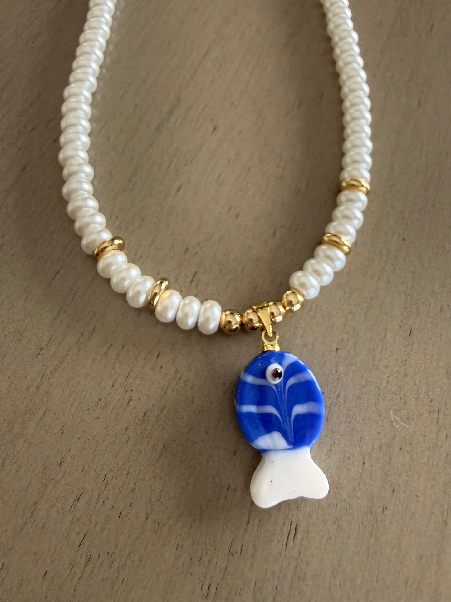 Pearl necklace with blue fish charm