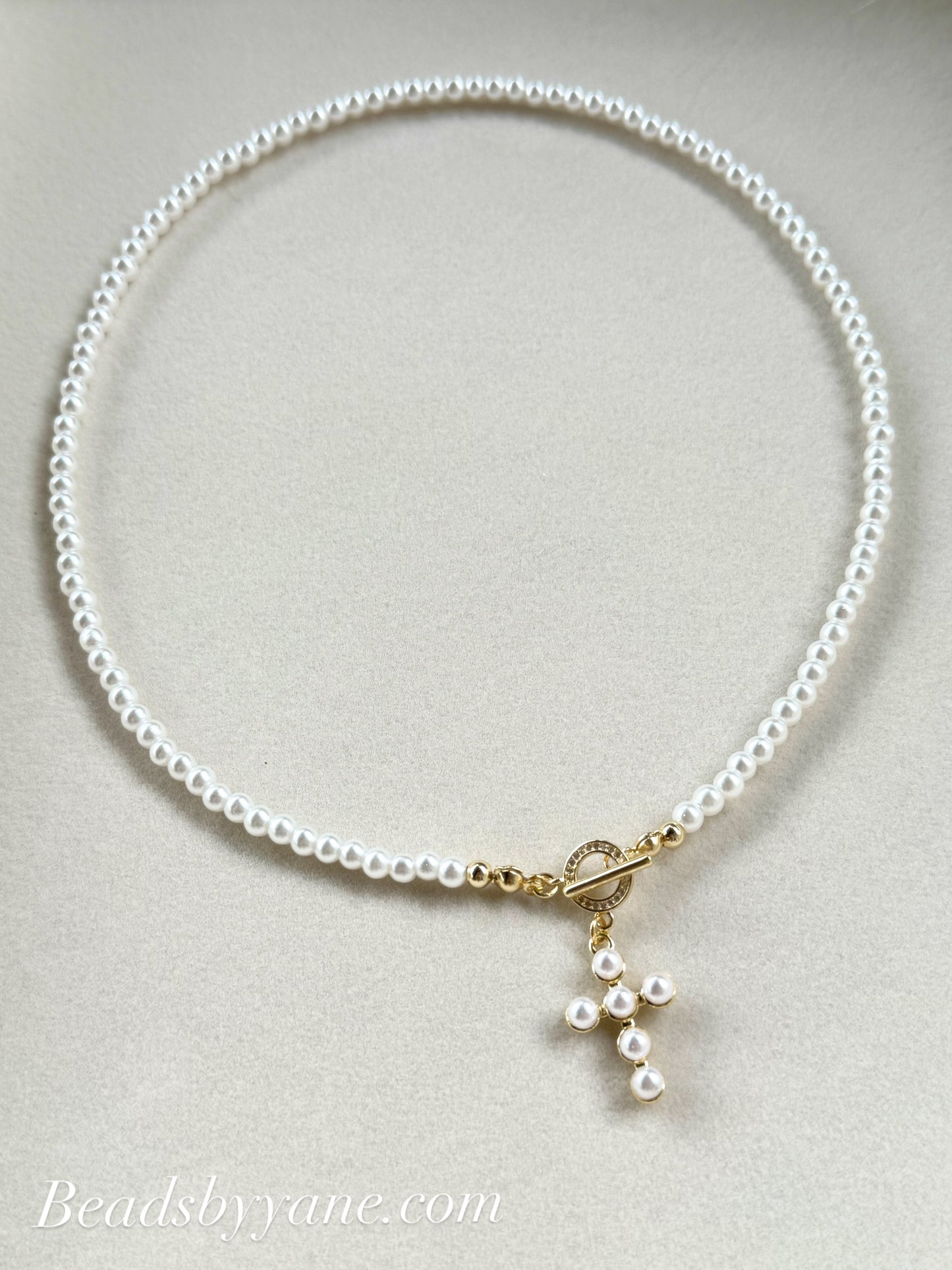 Dainty pearl necklace with cross